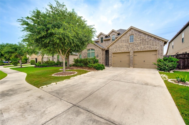 28418 Asher Falls Ln, Fulshear, TX 77441 - view of front of house featuring brick siding, driveway, and an attached garage
