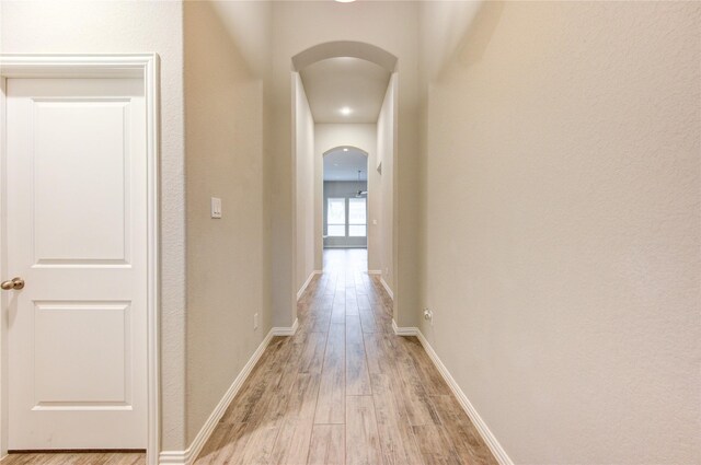 28418 Asher Falls Ln, Fulshear, TX 77441 - hall featuring arched walkways, light wood-style flooring, and baseboards