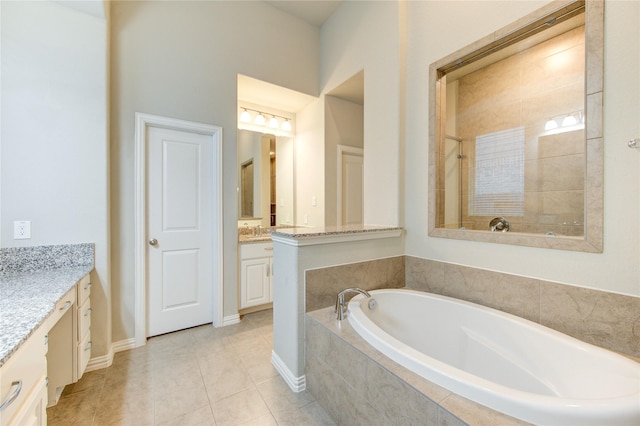 28418 Asher Falls Ln, Fulshear, TX 77441 - bathroom featuring vanity, a garden tub, tile patterned flooring, and baseboards