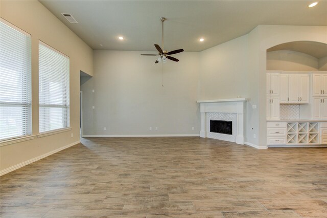 28418 Asher Falls Ln, Fulshear, TX 77441 - unfurnished living room featuring ceiling fan, light wood-type flooring, recessed lighting, a fireplace, and baseboards