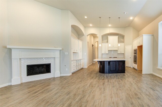 28418 Asher Falls Ln, Fulshear, TX 77441 - kitchen featuring open floor plan, appliances with stainless steel finishes, a sink, a kitchen island with sink, and light countertops