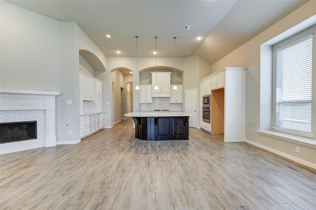 28418 Asher Falls Ln, Fulshear, TX 77441 - kitchen featuring open floor plan, appliances with stainless steel finishes, white cabinets, light countertops, and an island with sink