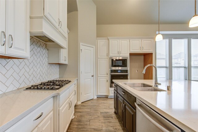 28418 Asher Falls Ln, Fulshear, TX 77441 - kitchen featuring appliances with stainless steel finishes, a sink, white cabinetry, and light wood-style floors