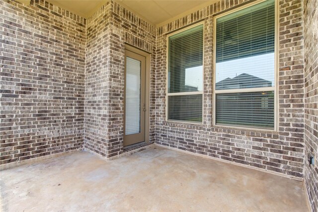 28418 Asher Falls Ln, Fulshear, TX 77441 - doorway to property with brick siding and a patio area