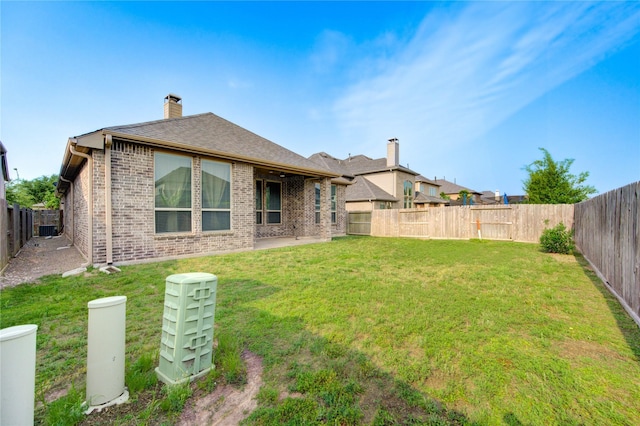 28418 Asher Falls Ln, Fulshear, TX 77441 - back of property featuring brick siding, a chimney, and cooling unit