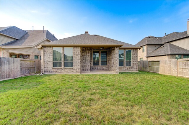 28418 Asher Falls Ln, Fulshear, TX 77441 - back of property featuring brick siding, a patio, and ceiling fan