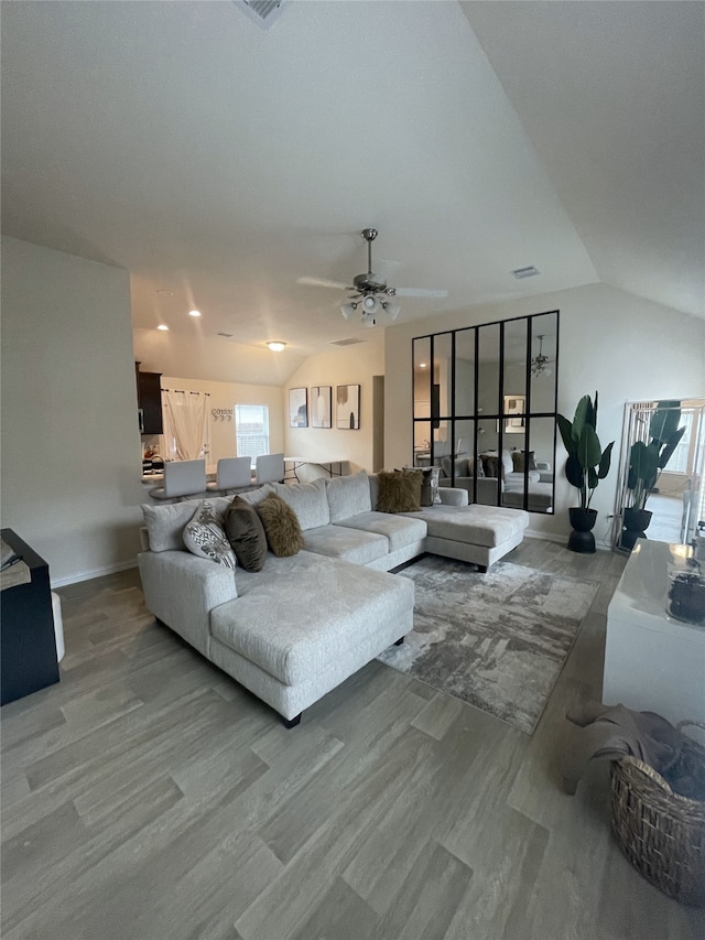 17768 Lionheart Rd, Conroe, TX 77306 - living area with lofted ceiling, plenty of natural light, ceiling fan, light wood-style floors, and baseboards