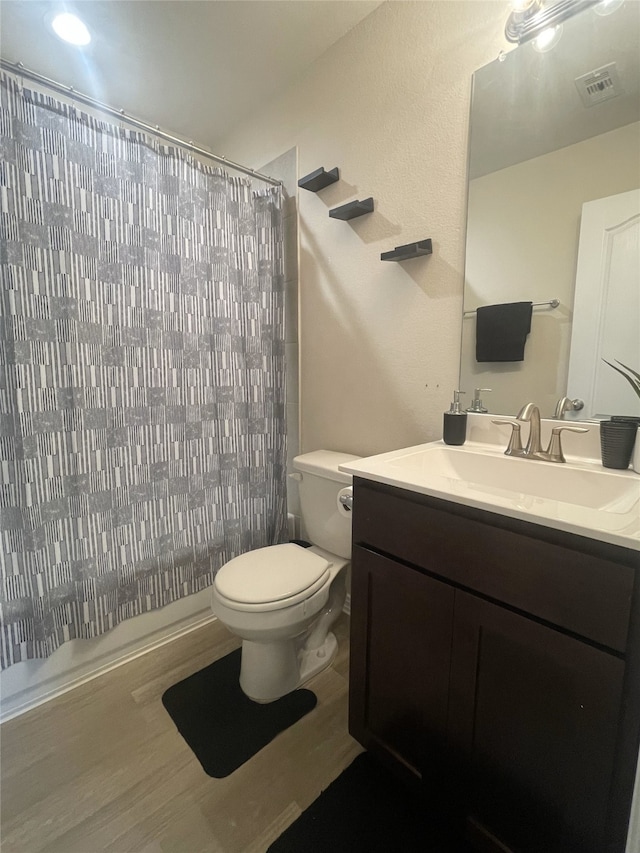 17768 Lionheart Rd, Conroe, TX 77306 - full bathroom featuring toilet, vanity, wood finished floors, and a shower with curtain