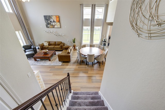 11702 Twin Creeks Hill Dr, Cypress, TX 77433 - stairs featuring healthy amount of natural light, wood finished floors, and a textured wall