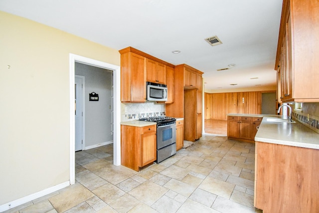 4721 Briarbend Dr, Houston, TX 77035 - kitchen featuring stainless steel appliances, a sink, decorative backsplash, light countertops, and recessed lighting