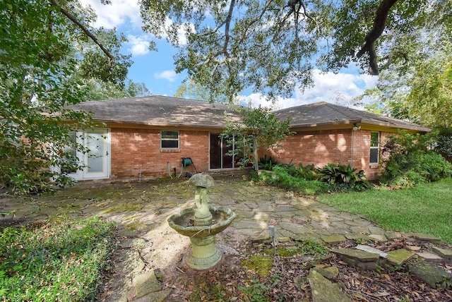 4721 Briarbend Dr, Houston, TX 77035 - back of property with a patio area, brick siding, and roof with shingles