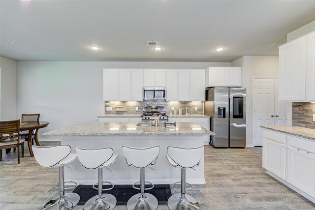 21430 Costalinda Dr, Cypress, TX 77433 - kitchen with appliances with stainless steel finishes, light wood-style flooring, light stone counters, and recessed lighting