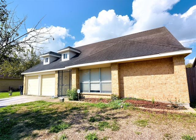 194 Moonridge Dr, Houston, TX 77015 - view of front of home with brick siding, a garage, roof with shingles, and concrete driveway