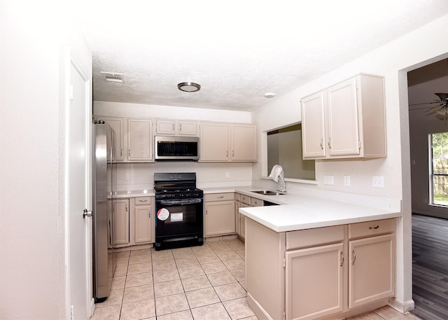 194 Moonridge Dr, Houston, TX 77015 - kitchen featuring appliances with stainless steel finishes, a sink, a peninsula, light countertops, and light tile patterned flooring
