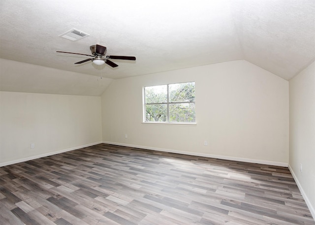 194 Moonridge Dr, Houston, TX 77015 - bonus room featuring lofted ceiling, wood finished floors, a textured ceiling, a ceiling fan, and baseboards