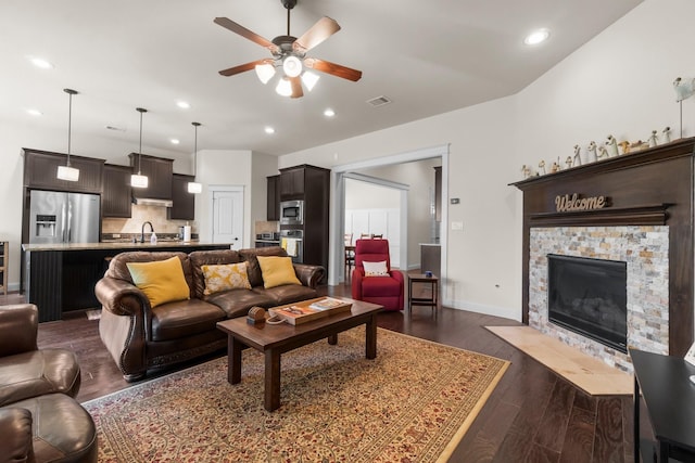 122 Cherry Oak Ln, Montgomery, TX 77316 - living area with a ceiling fan, recessed lighting, dark wood-type flooring, baseboards, and a stone fireplace