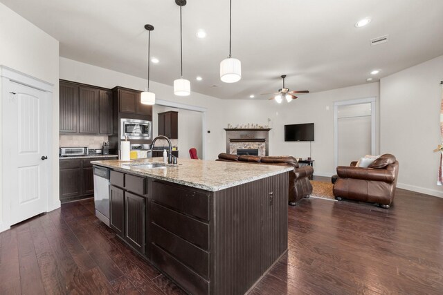 122 Cherry Oak Ln, Montgomery, TX 77316 - kitchen featuring appliances with stainless steel finishes, a sink, a ceiling fan, dark wood-style floors, and dark brown cabinets