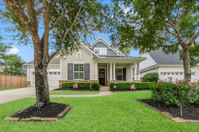 122 Cherry Oak Ln, Montgomery, TX 77316 - view of front of home featuring concrete driveway, an attached garage, covered porch, and stone siding