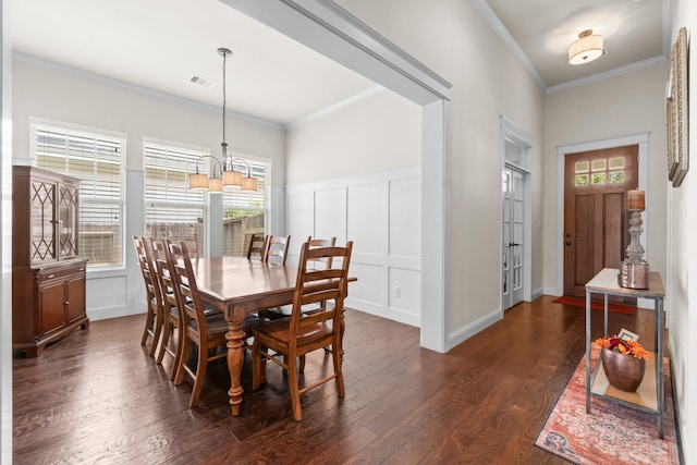 122 Cherry Oak Ln, Montgomery, TX 77316 - dining area with a chandelier, dark wood-type flooring, ornamental molding, and a decorative wall