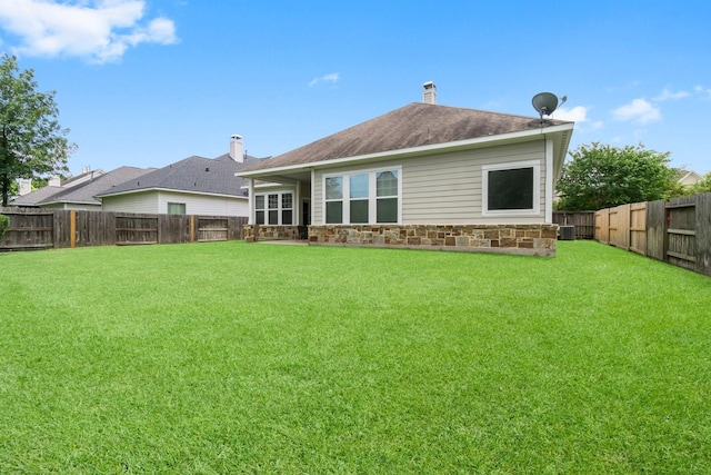 122 Cherry Oak Ln, Montgomery, TX 77316 - back of house featuring stone siding and central AC