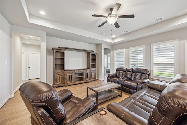 538 Still Water Ridge Ln, Sealy, TX 77474 - living room with light wood finished floors, a raised ceiling, a ceiling fan, plenty of natural light, and recessed lighting