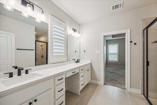 538 Still Water Ridge Ln, Sealy, TX 77474 - full bathroom with double vanity, a shower stall, and baseboards