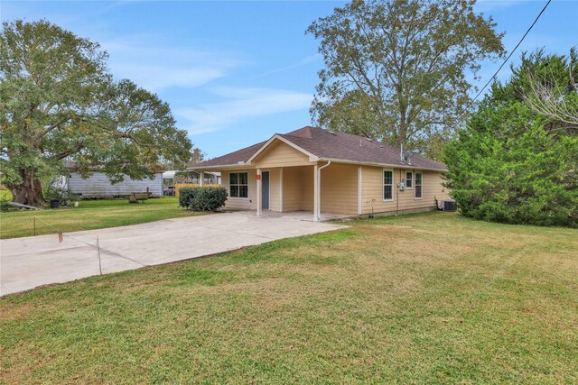 424 Baker Cir, Ames, TX 77575 - single story home with concrete driveway, a front lawn, and cooling unit