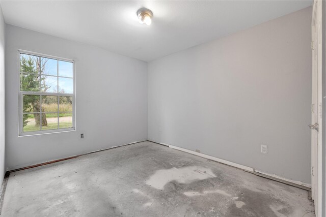 424 Baker Cir, Ames, TX 77575 - spare room with unfinished concrete floors