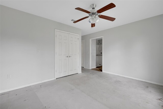 424 Baker Cir, Ames, TX 77575 - unfurnished bedroom featuring baseboards, concrete flooring, a closet, and ceiling fan