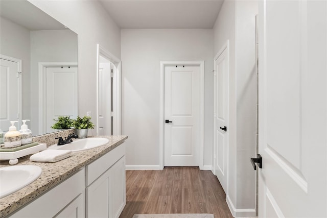 5732 Palm Flower Dr, Montgomery, TX 77316 - bathroom with wood finished floors, double vanity, and baseboards