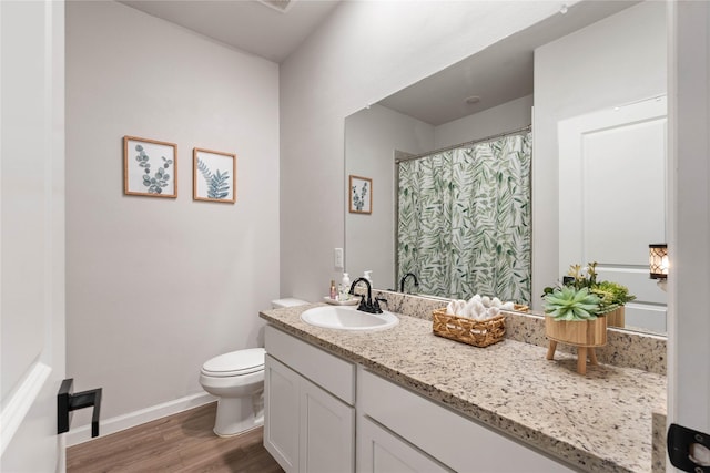 5732 Palm Flower Dr, Montgomery, TX 77316 - bathroom featuring wood finished floors, vanity, toilet, and baseboards