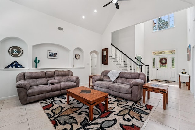 21885 Lost Mdw, New Caney, TX 77357 - living room with high vaulted ceiling, light tile patterned floors, ceiling fan, stairs, and baseboards