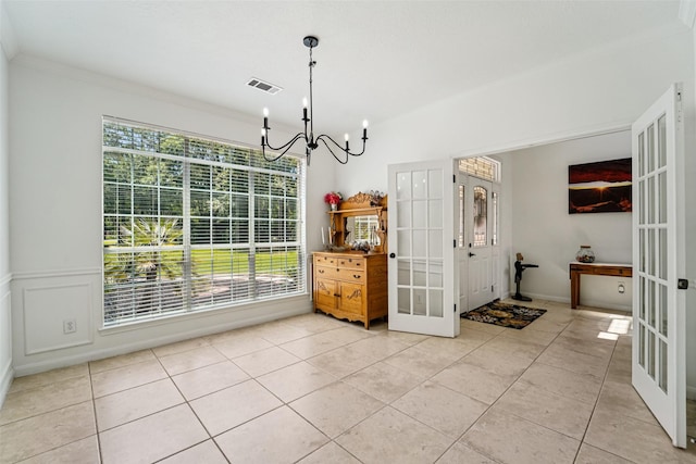 21885 Lost Mdw, New Caney, TX 77357 - dining area featuring french doors, a chandelier, light tile patterned flooring, and ornamental molding