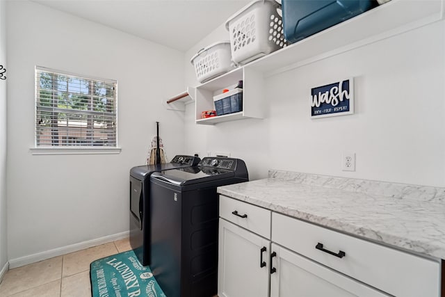 21885 Lost Mdw, New Caney, TX 77357 - washroom with washer and dryer, baseboards, light tile patterned flooring, and cabinet space