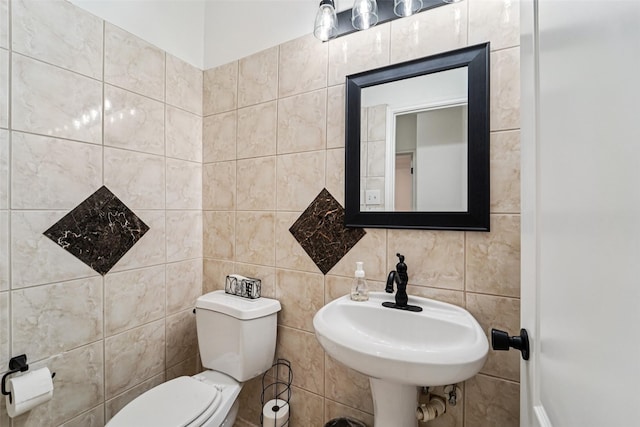 21885 Lost Mdw, New Caney, TX 77357 - bathroom with toilet, tile walls, and a sink