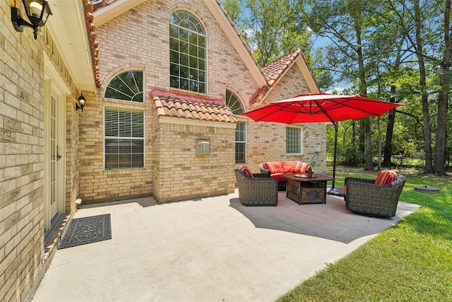 21885 Lost Mdw, New Caney, TX 77357 - view of patio with an outdoor living space with a fire pit