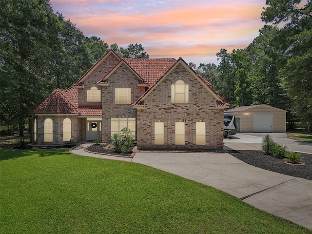 21885 Lost Mdw, New Caney, TX 77357 - traditional-style home with a tiled roof, concrete driveway, a garage, an outbuilding, and a yard