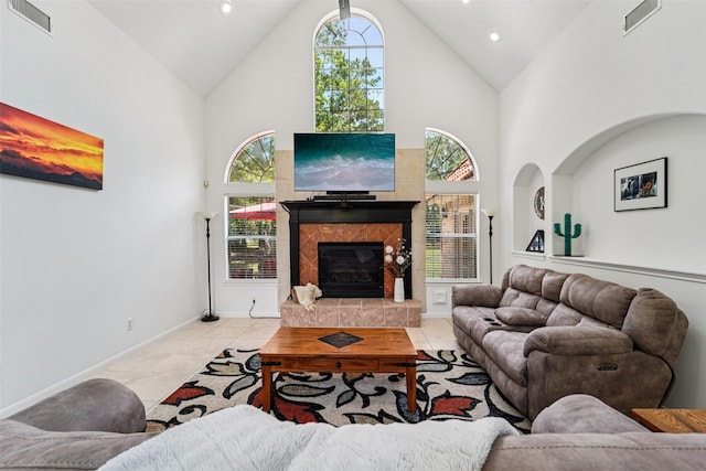21885 Lost Mdw, New Caney, TX 77357 - living area featuring high vaulted ceiling, tile patterned floors, a tile fireplace, recessed lighting, and a skylight