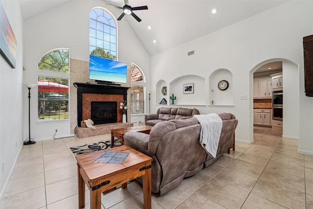 21885 Lost Mdw, New Caney, TX 77357 - living room featuring high vaulted ceiling, a ceiling fan, light tile patterned floors, recessed lighting, and a fireplace