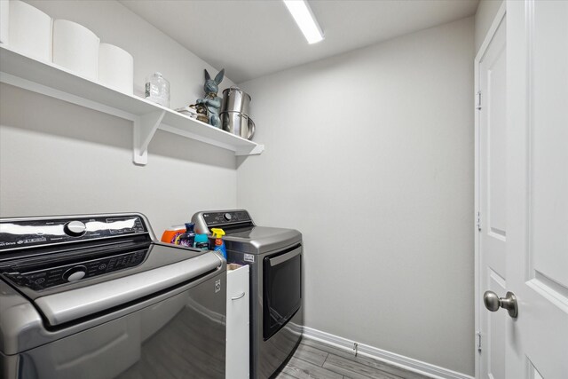 1010 Old Vine Rd, Brenham, TX 77833 - laundry area featuring washer and clothes dryer, baseboards, and light wood-style floors