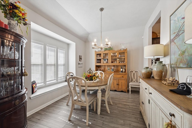 1010 Old Vine Rd, Brenham, TX 77833 - dining room with a chandelier, vaulted ceiling, wood finished floors, and baseboards