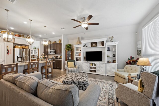 1010 Old Vine Rd, Brenham, TX 77833 - living area with ceiling fan, recessed lighting, wood finished floors, and a chandelier