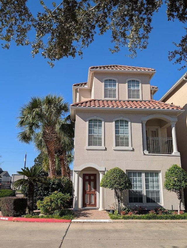 7222 Harmony Cv, Houston, TX 77036 - mediterranean / spanish-style house featuring a tile roof and stucco siding