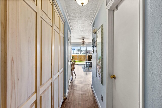 6300 Seawall Blvd Unit 9115, Galveston, TX 77551 - corridor with a textured ceiling, a textured wall, and dark wood-type flooring