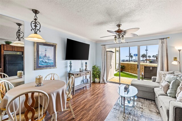 6300 Seawall Blvd Unit 9115, Galveston, TX 77551 - living room with ornamental molding, wood finished floors, a ceiling fan, and a textured ceiling