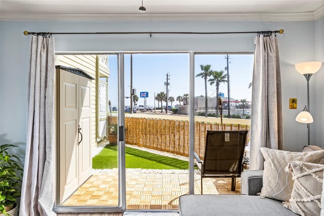 6300 Seawall Blvd Unit 9115, Galveston, TX 77551 - doorway to outside with crown molding and healthy amount of natural light