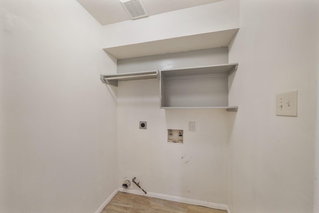 718 Presley Way, Sugar Land, TX 77479 - laundry room featuring hookup for a gas dryer, hookup for a washing machine, electric dryer hookup, light wood-style flooring, and baseboards