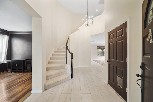 718 Presley Way, Sugar Land, TX 77479 - entryway featuring a chandelier, stairs, light wood-style flooring, baseboards, and a towering ceiling