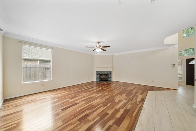 718 Presley Way, Sugar Land, TX 77479 - unfurnished living room with ceiling fan, light wood-style floors, a fireplace, crown molding, and baseboards