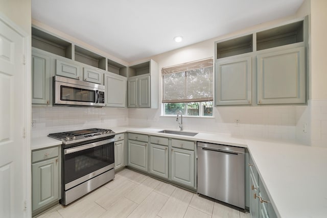 718 Presley Way, Sugar Land, TX 77479 - kitchen featuring stainless steel appliances, a sink, open shelves, gray cabinets, and tasteful backsplash